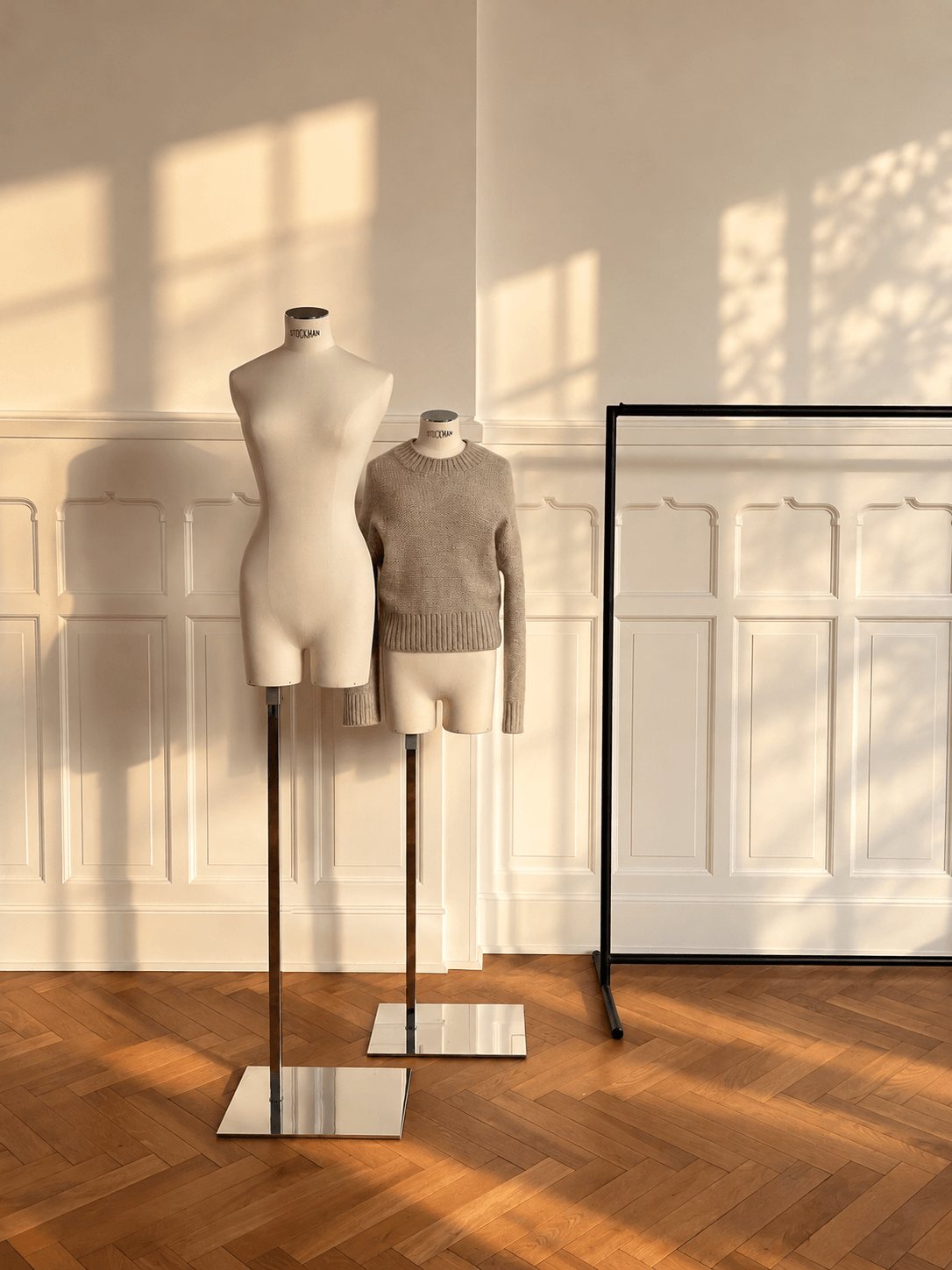 Two dress forms in the Berlin studio, one wearing a cashmere sweater