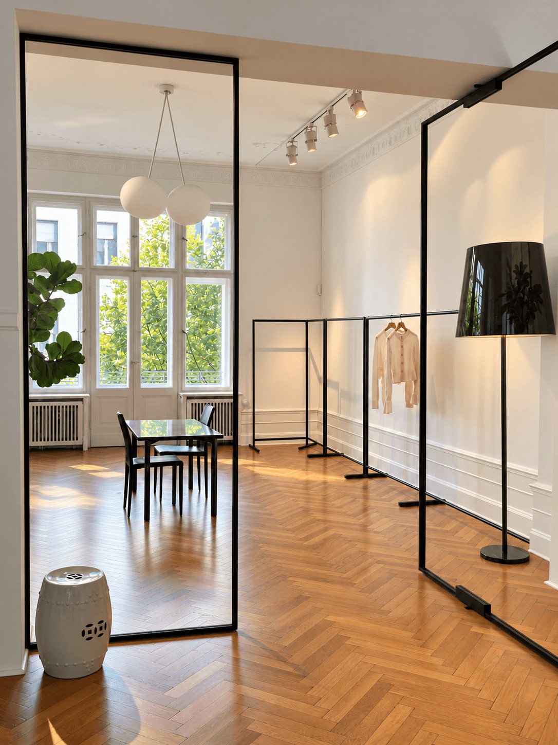 View through the studio into the showroom with rails and a fitting table